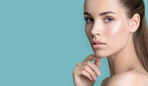 Woman with flawless skin touching her chin