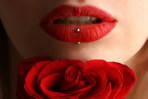 Women with red lips and a lip piercing